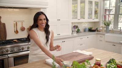 Meghan Markle's TV kitchen puts a modern twist on farmhouse style – her white cabinets, wooden countertops and hanging storage are cozy and inviting