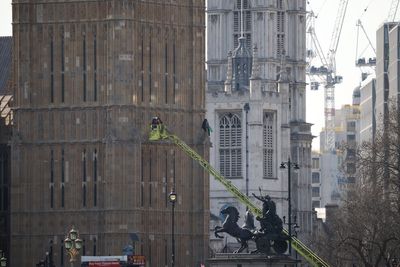 Emergency services arrive at Houses of Parliament as man climbs Big Ben with Palestinian flag