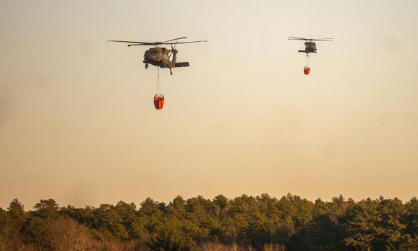 New York: firefighters continue to battle wind-driven brush fire on Long Island