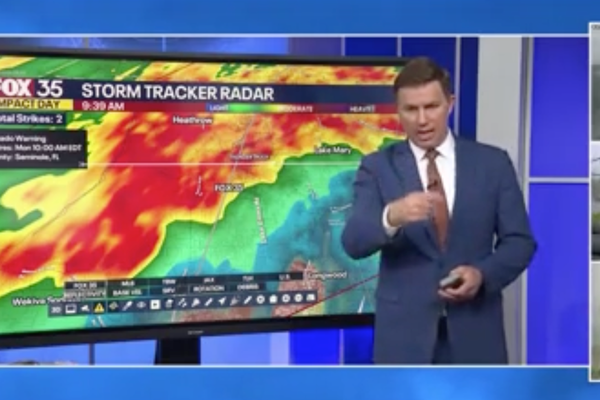 Moment tornado slams into TV station as weatherman is issuing warnings about impending storm