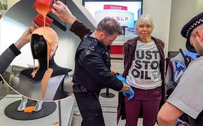 Just Stop Oil activists pour orange liquid over robot at Elon Musk's Tesla store in London