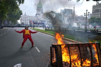 Argentine retirees and soccer fans clash with police during protests against austerity measures