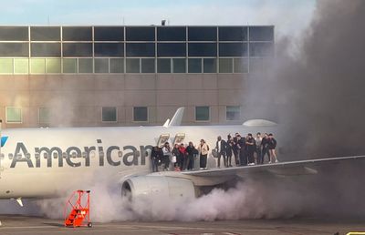 Passengers evacuate after American Airlines plane catches fire in Denver