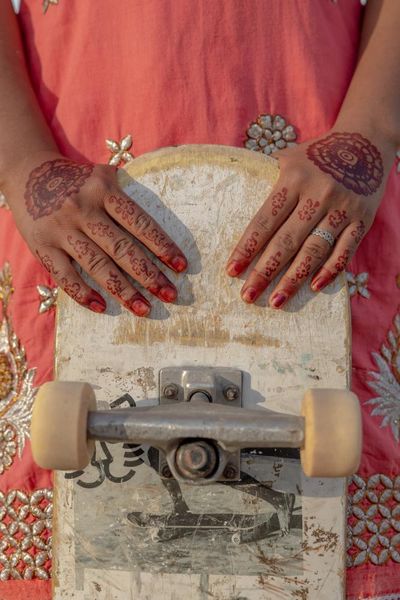 The big picture: a pioneering Indian skater girl shows off her prized board