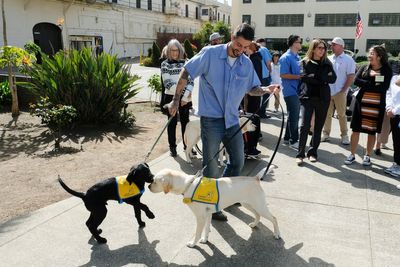 Tears and tail wags: Inmates reunite with service dogs they raised
