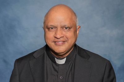 A man is in custody after the fatal shooting of a beloved Kansas priest