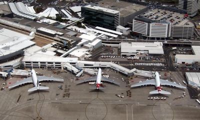 Man charged after allegedly attempting to open plane door on flight to Sydney