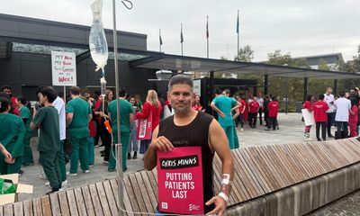 With a drip in his arm, this patient came out of a Sydney hospital to support striking doctors