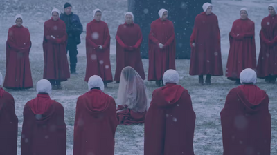 What is an Eye in The Handmaid's Tale and what does 'under his eye' mean?
