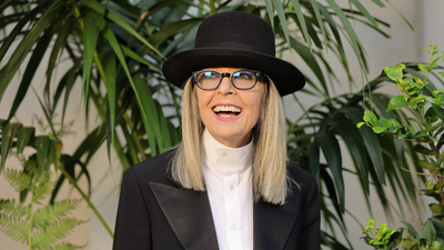 Diane Keaton uses glass cabinets to cleverly introduce color to her white kitchen – it's one of the most inventive decorating techniques I've ever seen