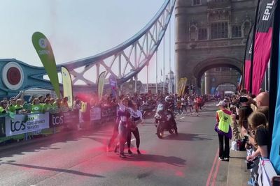 Protesters disrupt London Marathon with powder demonstration on Tower Bridge