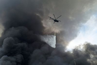 Iran's president visits those injured in port explosion that killed at least 28 people
