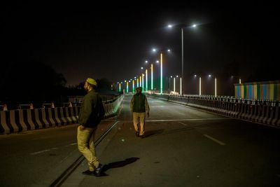 At least 12 killed after speeding van hits bike and falls into well