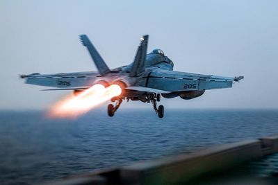US fighter jet rolls off aircraft carrier as ship reportedly swerves Houthi fire