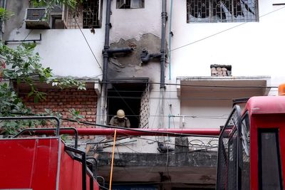 Two children among 15 dead as guests jump from windows to escape fire at six-storey hotel in India