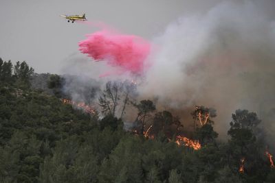 A wildfire closes main highway linking Tel Aviv to Jerusalem and sends 12 people to the hospital