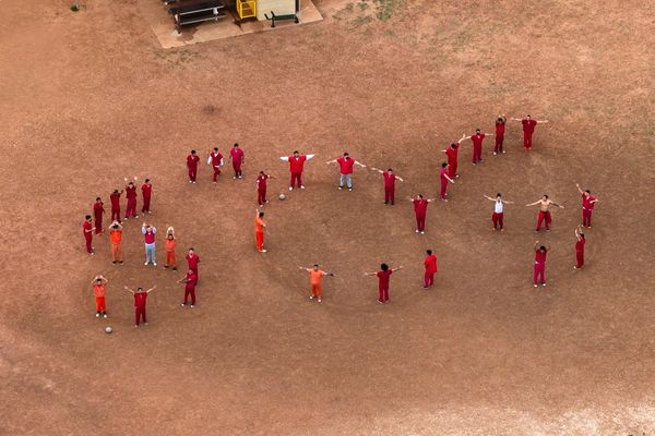 Inmates awaiting deportation make giant ‘SOS’ message with their bodies that can be seen from the skies
