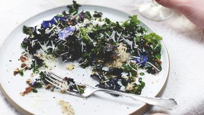 Caesar-style salad of baby kale, spring herbs and flowers with pecorino crisps