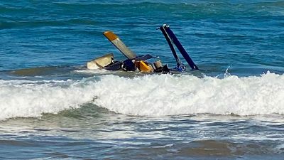Three people rescued from seaside helicopter crash