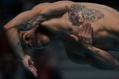 AP PHOTOS: Expressions of divers in the split second between diving board and the water