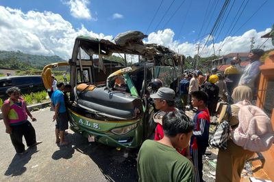Out-of-control bus careens down hill and overturns, killing 12