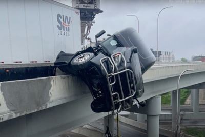 Terrifying moment trucker calls 911 while in his cab hanging off a bridge