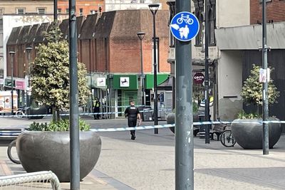 Two men arrested after customer stabbed to death in city centre bank