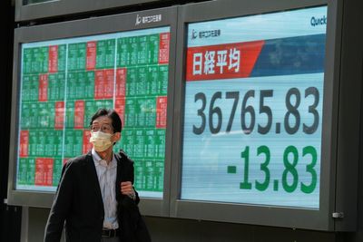 Asian shares trade higher after Wall Street climbs moderately as Fed holds rates steady