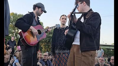"It's not a political statement, it is a human reaction to a horrific and unimaginable situation." Watch The Murder Capital perform a free acoustic gig in a Cologne park after two German gigs are cancelled over Palestinian flag display