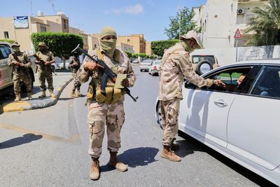 A warlord and 6 other people killed as militia infighting rocks Libya's capital, officials say