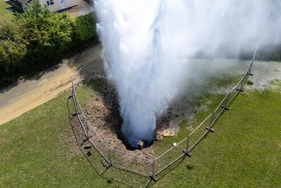 Watch: Huge jet of water sprays across homes as burst main floods streets