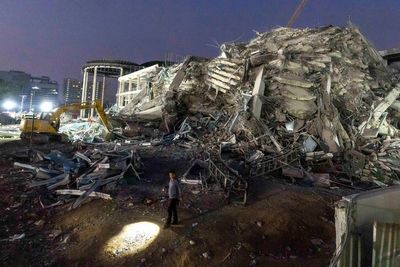 Thai construction magnate and others surrender to police on charges over building collapse in quake