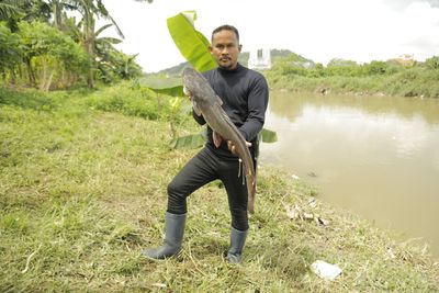 Malaysia’s ‘fish hunters’ target invasive species, one catch at a time