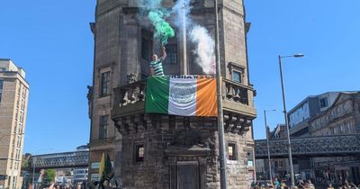 Celtic fans climb historic Scottish building at club's unofficial title party