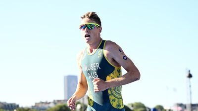 Hauser sprints to triathlon victory, leads world series