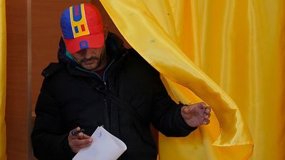 Romanians vote in cliffhanger presidential election as tensions continue to rise