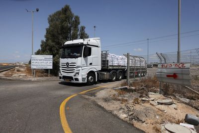 Israel allows first aid trucks to enter Gaza as Netanyahu says forces will take full control of territory