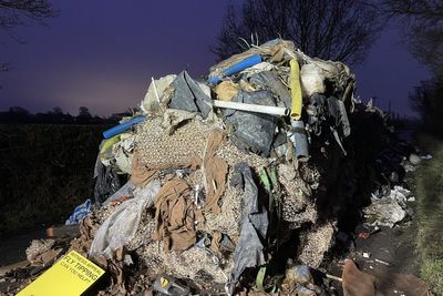Man and business charged over 27-tonne mound of waste that blocked road