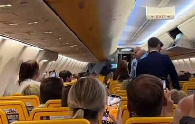 Moment British woman is dragged off Ryanair flight 'after assaulting travellers and making bomb threat'