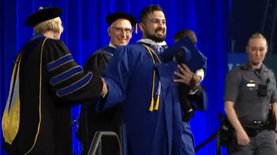 College Grad Chased Down by Officers as He Carries Infant Son Across Graduation Stage