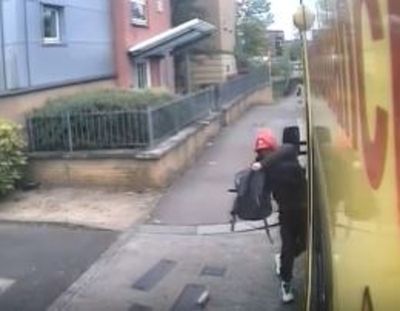 Shocking moment brazen thief steals paramedics' belongings as they treat patient