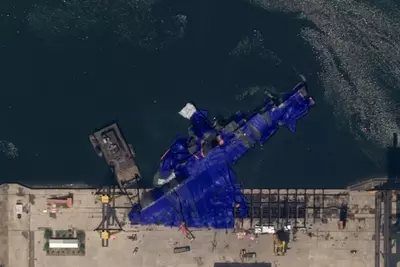 Watch: Satellite images show North Korean warship laying on its side after botched launch