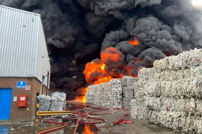Black smoke seen as firefighters tackle large fire at recycling warehouse