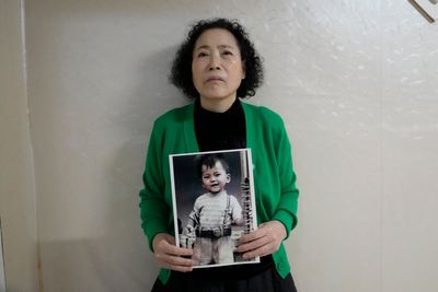 A South Korean mother sues the government and an agency over the adoption of her missing son