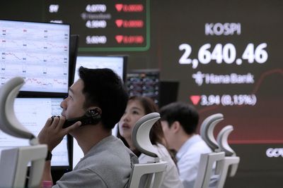 Asian shares mostly lower, trading in a narrow range with US markets closed for Memorial Day
