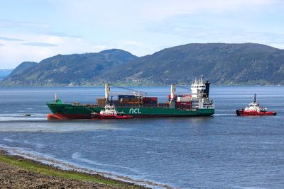 A cargo ship that ran aground in Norway, narrowly missing a house, is being towed to a nearby harbor