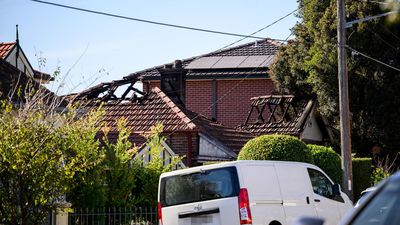 Man dead in house fire amid search for younger relative