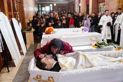 AP PHOTOS: Three Ukrainian Siblings Buried in Aftermath of Russian Missile Strike