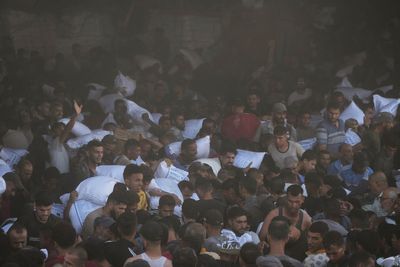 AP PHOTOS: Chaos as hungry Palestinians overrun a Gaza aid site