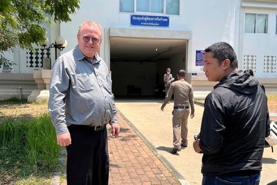 US scholar leaves Thailand after charges of insulting monarchy are dropped